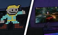 The Fallout Vault Boy made out of small square blocks on one side of a diagonal white line. On the other, a black monitor with a car game on the screen sat on a desk.