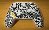 A white Xbox-style controller featuring Fortnite all over it in black, except one gold branding on the left side.